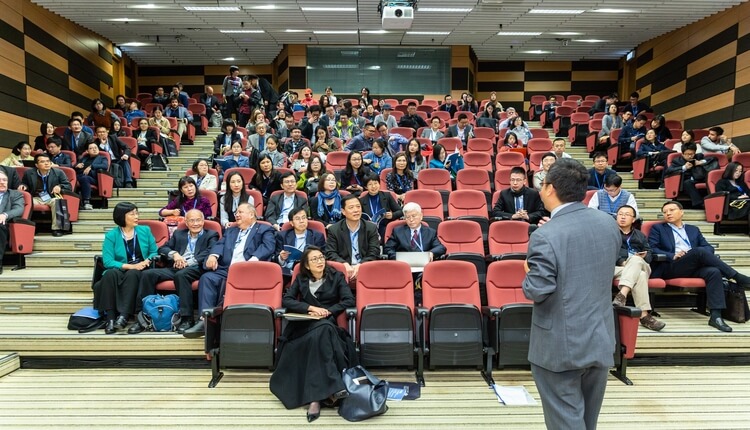 a university hall full of people at a conference