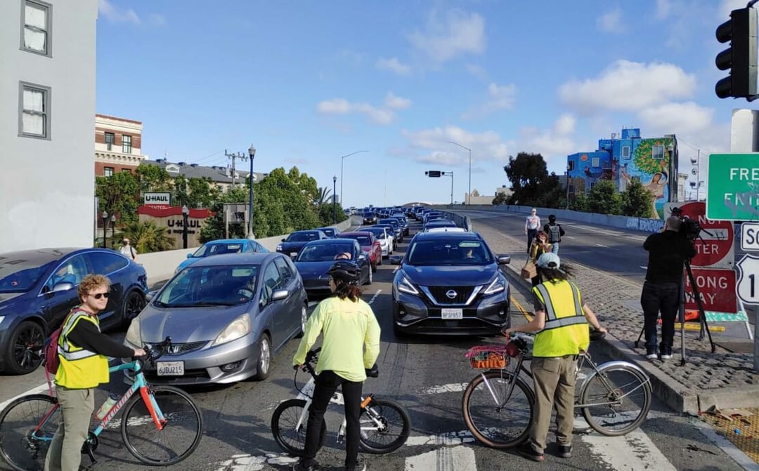 Several people blocking a major road with bicycles
