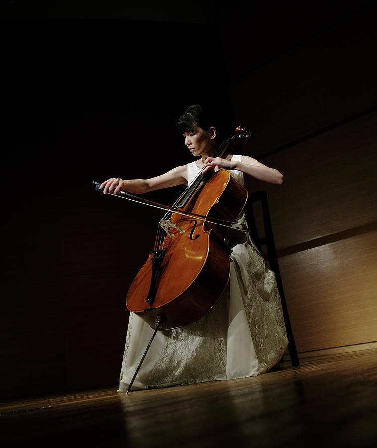 a woman playing a cello
