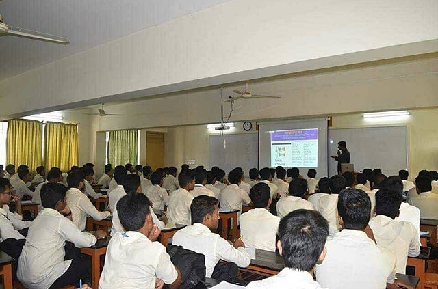 a picture of a classroom full of students, with a teacher up front