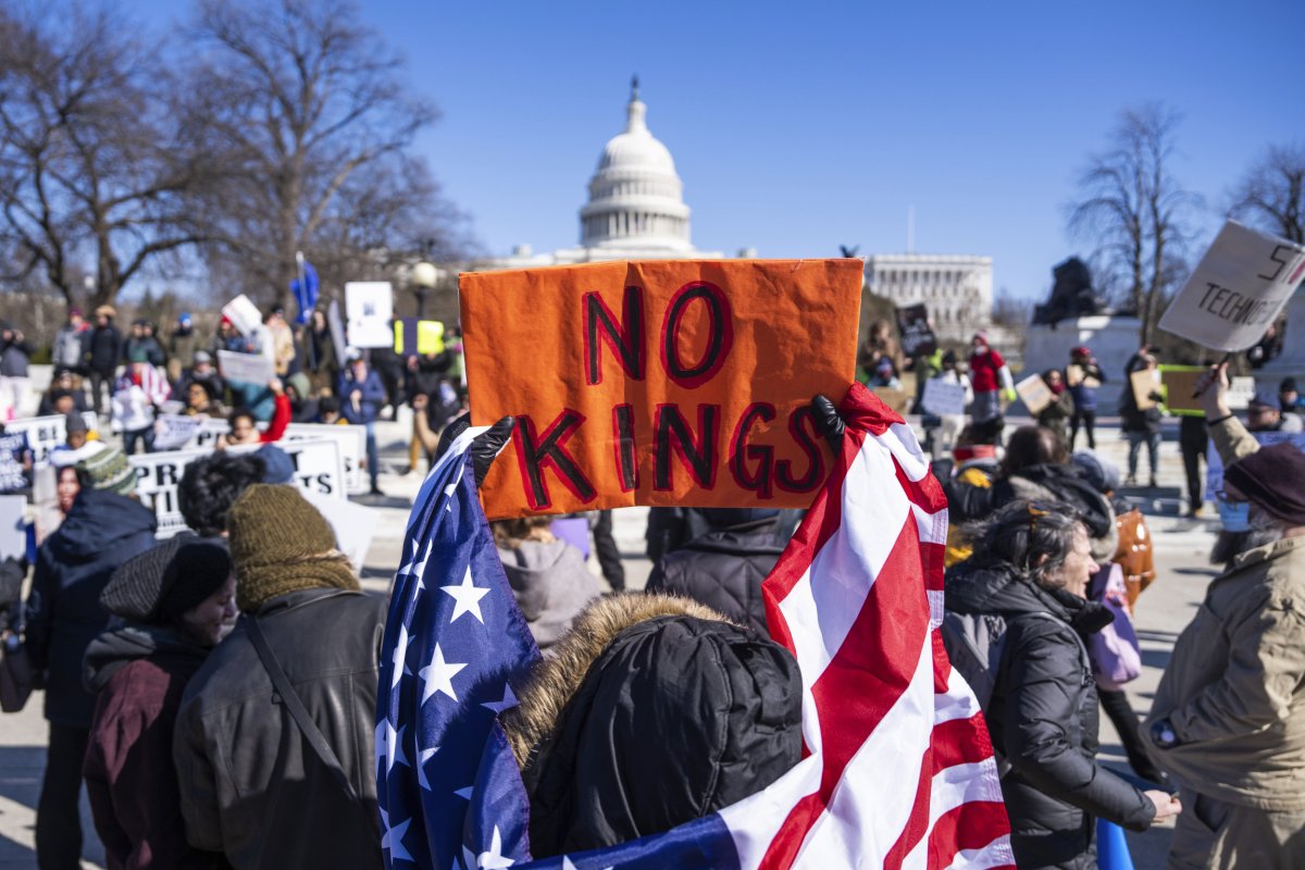 A picture of protesters holding a sign that says 'No Kings'