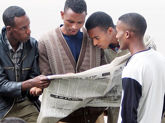 Four men reading a newspaper in Addis Ababa, Ethiopia